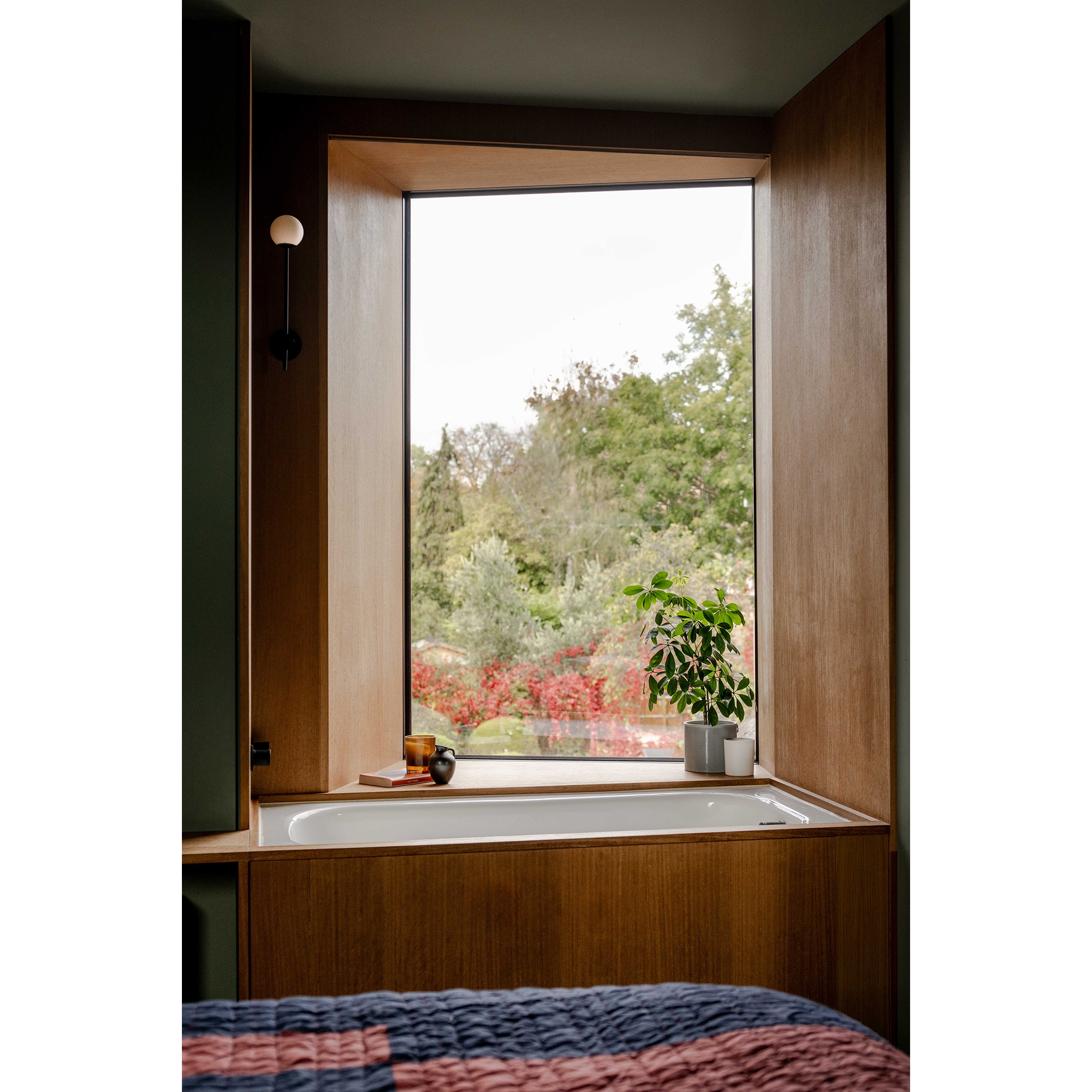 The hidden bath in front of a window in the loft bedroom