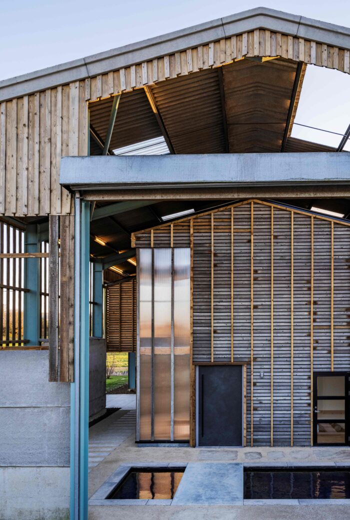 The front entrance of this unusual new sustainable barn conversion , which is built inside an existing modern barn.